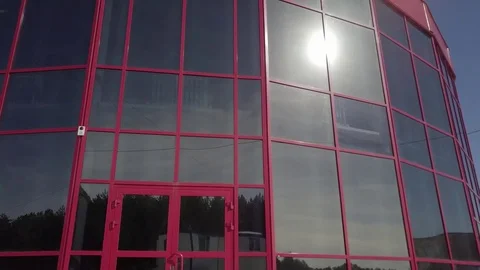 Red building with tinted glass windows Stock Footage 74346983
