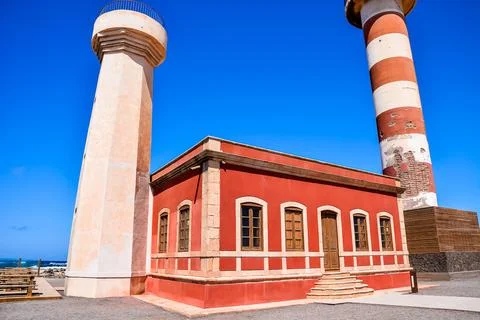A red building with a white tower in the background Stock Photos