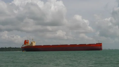 Red bulk carrier cargo ship anchored near Singapore coast Stock-Footage 337834146
