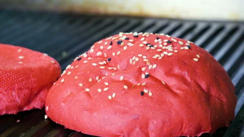 Red bun. Two halves of hamburger bread are being fried on a grill for burger. 4K Stock Footage 98026330