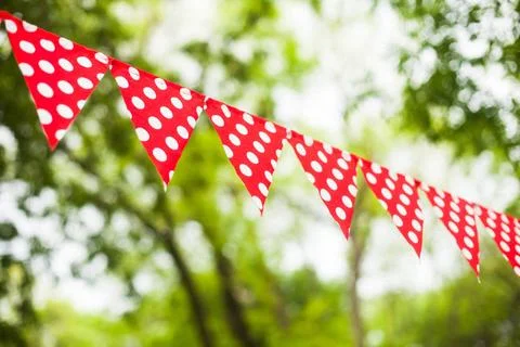 Red bunting flags Red triangular flags with white dots on the nature backg... Stock Photos