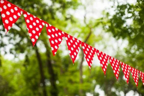 Red bunting flags Red triangular flags with white dots on the nature backg... Stock Photos