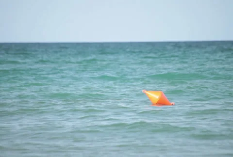Red buoy floating on ocean waves Stock Footage 37678912