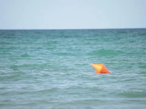 Red buoy floating on ocean waves Video stock 37707910