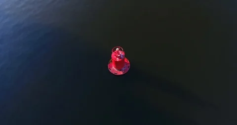 The red buoy floating on the river.  Sunlight reflecting on the calm water. 스톡 동영상 92910428