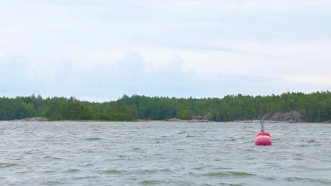 Red buoys floating on the calm blue waters of Baltic sea in Finland, marina on t Stock Footage 280406895