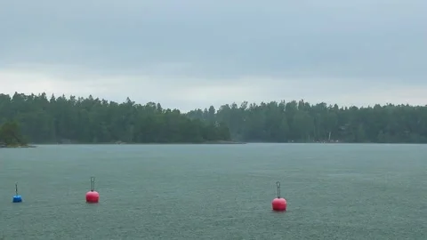 Red buoys floating on the calm waters of Baltic sea in Finland under the rain, Stock Footage 280405926