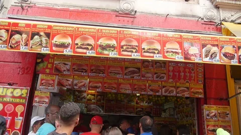 Red Burger Stand Full of Queue Visitors - Hand Held Stock Footage 119298974