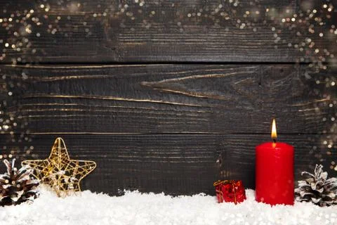 Red burning candle with black rustic wooden board Stock Photos