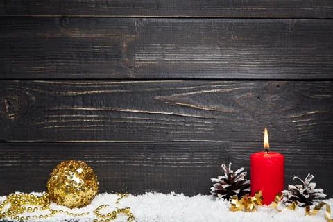 Red burning candle with black rustic wooden board Stock Photos