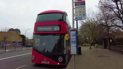Red bus coming to bus stop in London. Stock Footage 276302419