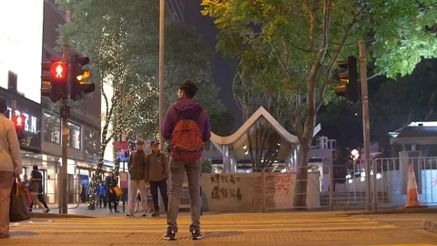 Red Bus Drives by the Traffic Light in Hong Kong at Nighttime 4k Stock Footage 123142121