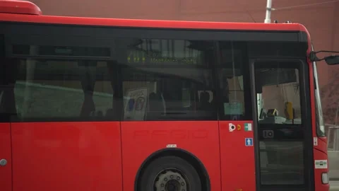 A red bus is driving through the center Stockbeeldmateriaal 232482519