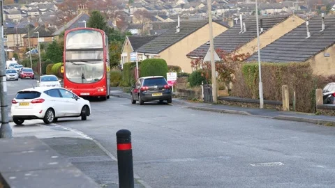 Red bus pulls out from roadside  bus top in front of cars Stock Footage 150865572