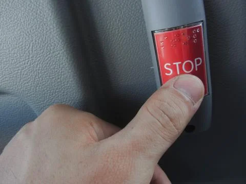 A red bus stop request button Foto stock