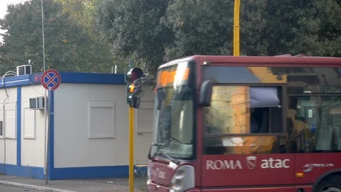 A red bus turning right at an intersection with yellow flashing light and Stock Footage 120298189