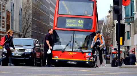Red Bus waiting at traffic lights &amp; Pedestrians Stock Footage 36594014