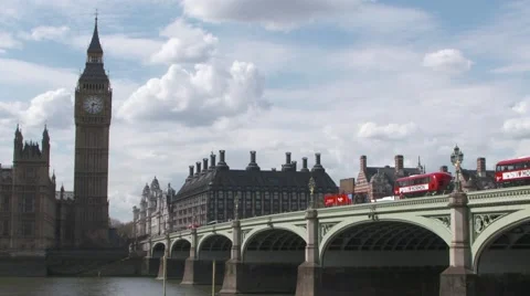 Red buses going across Westminster Bridge towards Big Ben Stock Footage 62420378