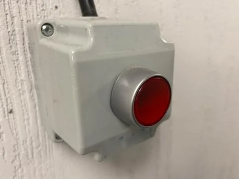 Red button. Big red button on wall. The Production emergency button pushing.  Stock Photos