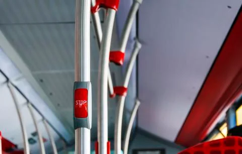 Red button to book the stop in a public bus. Photos