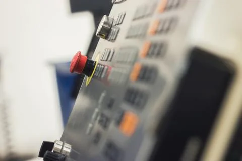 Red button of control panel machine processing metal, industrial background Stock Photos