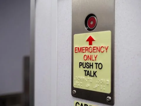 Red button with emergency only push to talk text with braille Stock Photos
