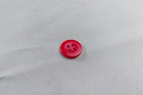 A red button on the fabric texture Stock Photos