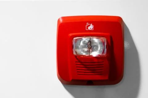 Red button warning light flasher fire alarm on the wall Photos