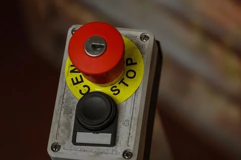 Red button with the word stop. Emergency stop button with key. Stock Photos
