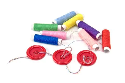 Red buttons and thread spools  on white background Stock-Fotos