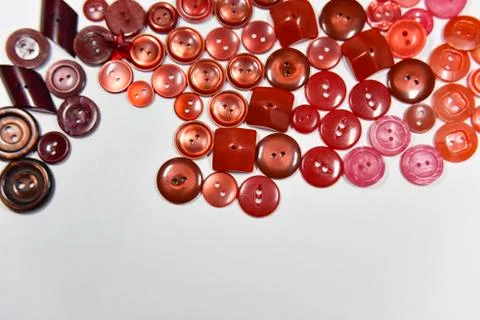 Red buttons of different shape and size on the white background. Selective fo Stock Photos