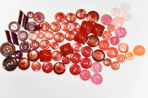 Red buttons of different shape and size on the white background. Selective fo Stock Photos