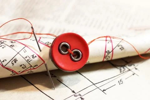 Red buttons on paper pattern, sewing theme Stock Photos