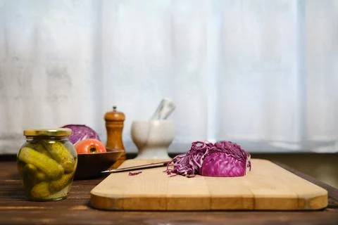 Red cabbage and ingredients on kitchen table Stock Photos