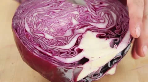 Red cabbage being quartered and the stem being removed Stock Footage 24648382