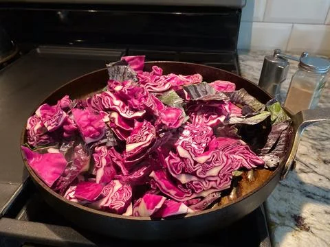 Red cabbage closeup in a pan being sauteed Stock Photos