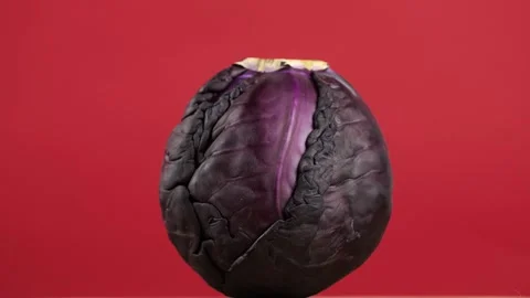 Red cabbage rotates on a red background Stock Footage 273834754
