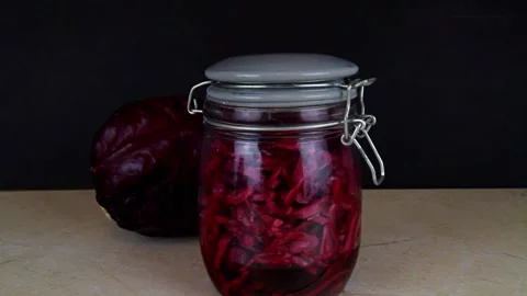 Red cabbage sauerkraut with cabbage behind, landscape, panning right to left. Stock Footage 199810296