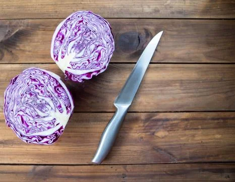 Red cabbage on a wooden table with knife Stock Photos