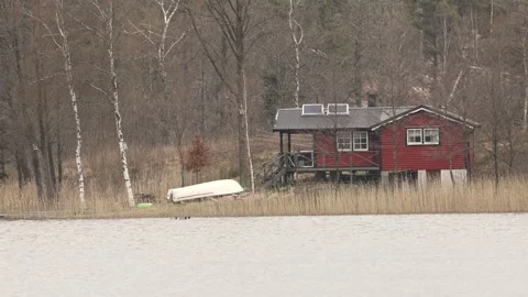 Red cabin by the lake Stock Footage 240194776