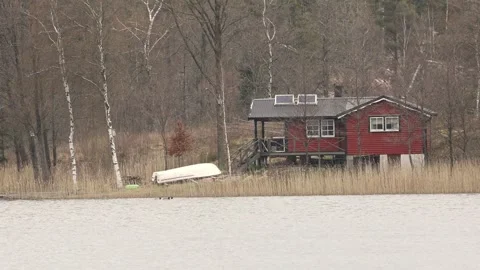 Red cabin by the lake Stock Footage 240194790