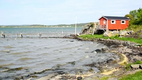 Red cabin by the sea Stock Footage 90988359