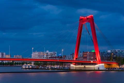 Red cable bridge against cloudy sky at night Stock Photos