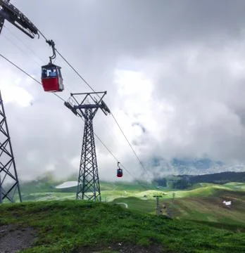 Red cable cabin down from Mannlichen with scenic view in Grindelwald Stock Photos