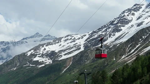 Red cable car in the background of the mountains Old red cable car at mountain. Stock Footage 130873249