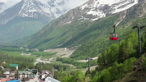 Red cable car in the background of the mountains Russia, Elbrus-June, 2019 Stock Footage 130873342