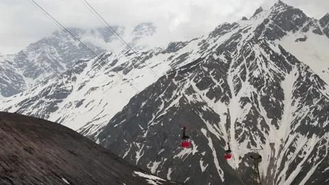 Red cable car on the background of mountains covered with snow. aerial Stock Footage 136519587