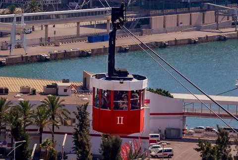 Red cable car cabin with passengers in Barcelona, Spain. Stock Photos