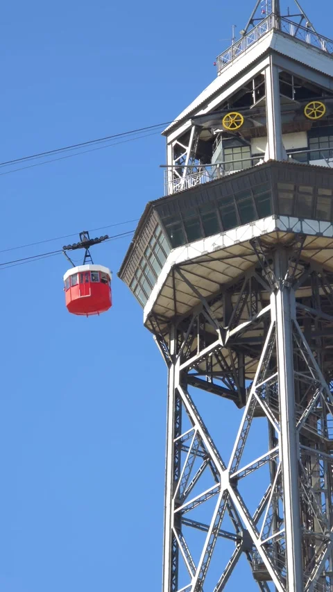 Red cable car moving across a clear blue sky. Stock Footage 312514395