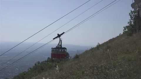 The red cable car is moving up with the people in the city Pyatigorsk Stock Footage 301775338
